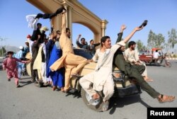 People celebrate the cease-fire in Rodat district of Nangarhar province, Afghanistan, June 16, 2018.