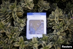 FILE - Pope Francis' encyclical titled "Laudato Si (Be Praised), On the Care of Our Common Home" is displayed during the presentation news conference at the Vatican, June 18, 2015.