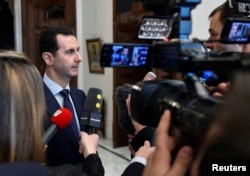 Syria's President Bashar al-Assad speaks to French journalists in Damascus, Syria, Jan. 9, 2017.
