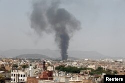 FILE - Smoke rises from a snack food factory after a Saudi-led air strike hit it in Sana'a, Yemen, Aug. 2016.