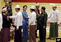 Aung San Suu Kyi, center, shakes hands with Senior General Min Aung Hlaing after the presidential handover ceremony in Naypyitaw, Myanmar, Wednesday, March 30, 2016. (Nyein Chan Naing/Pool Image via AP)