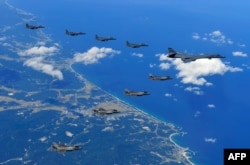 This handout photo taken Sept. 18, 2017 and provided by the South Korean Defense Ministry in Seoul shows U.S. and South Korean fighter jets flying over South Korea during a joint military drill aimed to counter North Korea’s latest nuclear and missile tes
