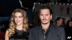FILE - Actor Johnny Depp and wife Amber Heard