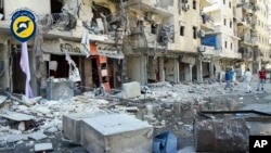In this photo provided by the Syrian Civil Defense White Helmets, men stand in rubble after airstrikes hit eastern Aleppo, Syria, Sept. 9, 2016.