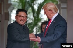 U.S. President Donald Trump meets North Korean leader Kim Jong Un at the Capella Hotel on Sentosa island in Singapore, June 12, 2018.