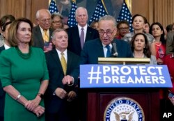 FILE - Senate Minority Leader Chuck Schumer of New York, accompanied by House Minority Leader Nancy Pelosi of California, left, and others members of the House and Senate Democrats, speaks during a news conference on Capitol Hill in Washington, Sept. 6, 2017.