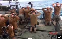 FILE - U.S. Navy sailors detained by the Iranian Revolutionary Guards in the Persian Gulf, Iran, are shown in this photo released by the Iranian state-run IRIB News Agency. Jan. 13, 2016.