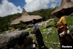Dua perempuan Sumba meletakkan sesajen buah pinang di Desa Wunga, di Haharu, Kabupaten Sumba Timur, 24 Februari 2020. (Foto: Reuters)