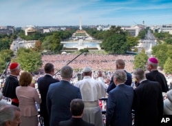Pope Francis waves to the assembled crowd from the Speakers Balcony at the U.S. Capitol with members of Congress, Thursday, Sept. 24, 2015, in Washington after he addressed a joint meeting of Congress. (Doug Mills/The New York Times via AP, Pool)