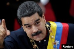 Venezuela's President Nicolas Maduro gestures as he arrives for a session of the National Constituent Assembly at Palacio Federal Legislativo in Caracas, Venezuela, Aug. 10, 2017.