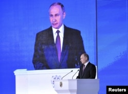 Russian President Vladimir Putin addresses Russian lawmakers, regional governors and other high-ranking officials, in Moscow, Russia, March 1, 2018.