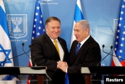 FILE - Israeli Prime Minister Benjamin Netanyahu shakes hands with U.S. Secretary of State Mike Pompeo during a meeting at the Ministry of Defense in Tel Aviv, Israel, April 29, 2018.