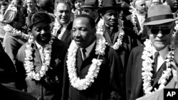 FILE - Martin Luther King Jr. and other civil rights marchers cross the Edmund Pettus Bridge in Selma, Ala., March 21, 1965.