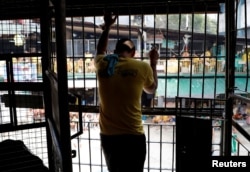 A detainee watches a basketball game inside the city jail of Quezon City, Metro Manila, Philippines, July 8, 2017.