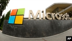 FILE - Tthe Microsoft Corp. logo appears outside the Microsoft Visitor Center in Redmond, Washington, July 3, 2014.