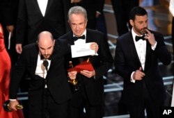Jordan Horowitz shows the envelope revealing "Moonlight" as the true winner of best picture at the Oscars, Feb. 26, 2017, at the Dolby Theatre in Los Angeles.