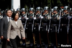 Taiwanese President Tsai Ing-wen inspects honour guard before a ceremony to mark the 92nd anniversary of the Whampoa Military Academy, in Kaohsiung, southern Taiwan, June 16, 2016.