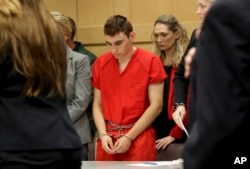 FILE - Nikolas Cruz appears in court for a status hearing before Broward Circuit Judge Elizabeth Scherer in Fort Lauderdale, Fla., Feb. 19, 2018.
