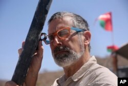 Peter Kelemen, head of the Oman Drilling Project, checks a fresh rock core sample during a geological research project in the al-Hajjar mountains of Oman, March 1, 2017.