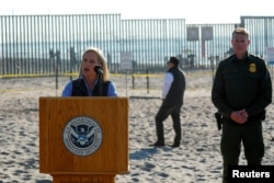 FILE - U.S. Secretary of Homeland Security Kirstjen Nielsen speaks next to the U.S. Mexico border at Border Field State Park in San Diego, California, Nov. 20, 2018.