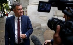 FILE - Then-Conservative MP David Gauke talks to the media in Westminster, in London, Britain, Sept. 24, 2019.