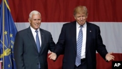 Indiana Gov. Mike Pence joins Republican presidential candidate Donald Trump at a rally in Westfield, Indiana, July 12, 2016. Trump announced Pence as his running mate Friday.