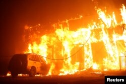 A structure is engulfed in flames during the Camp Fire in Paradise, California, Nov. 8, 2018.