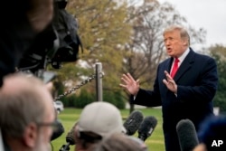 President Donald Trump speaks to members of the media before boarding Marine One on the South Lawn of the White House in Washington, Nov. 26, 2018.