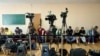 FILE - Journalists wait for President Volodymyr Zelenskiy's arrival at a polling station during parliamentary elections, in Kyiv, Ukraine, July 21, 2019. 