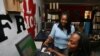 Ciata Victor instructs an unidentified lady inside her Internet cafe in Monrovia, (File photo).