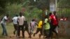A crowd runs for cover as African Union (AU) peacekeeping soldiers fire warning shots to disperse a crowd near the district of Miskine in Bangui, Feb. 7, 2014. 