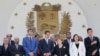 U.N. High Commissioner for Human Rights Michelle Bachelet, third right, poses for a photo with Venezuela's self proclaimed President Juan Guaido, center, and other opposition lawmakers on the steps of the national assembly in Caracas.
