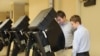 Dominic Scavuzzo, 18, cast his ballot in primary elections, accompanied by candidate Tyler Ruzich, who was too young to vote.