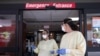 FILE - Nurses talk outside the emergency room at Beaumont Hospital as they manage an influx of COVID-19 cases in Grosse Pointe, Michigan, April 16, 2021.