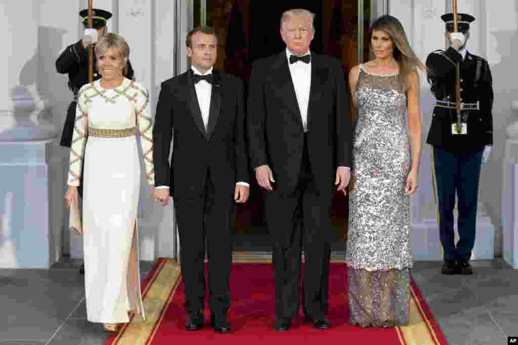 President Donald Trump, first lady Melania Trump, French President Emmanuel Macron and his wife Brigitte Macron, pose for photographs as they arrive for a State Dinner at the White House in Washington, April 24, 2018.