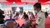 Seorang penyandang disabilitas menerima suntikan vaksin COVID-19 Sinovac saat vaksinasi massal di Stadion Patriot Candrabhaga, Bekasi, Senin, 14 Juni 2021. (AP Photo/Achmad Ibrahim)
