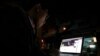 FILE - A Vietnamese internet activist posts a status on Facebook at a cafe in Hanoi, Nov. 27, 2013.