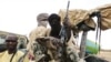 FILE - Militiaman from the Ansar Dine Islamic group sit on a vehicle in Gao, in northeastern Mali, June 18, 2012. 
