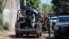 FILE - Federal forces guard the perimeter of a scene following a shootout where several suspected gang members were killed while one local cartel leader was arrested, on the outskirts of Culiacan, Sinaloa state, Mexico Oct. 22, 2024.