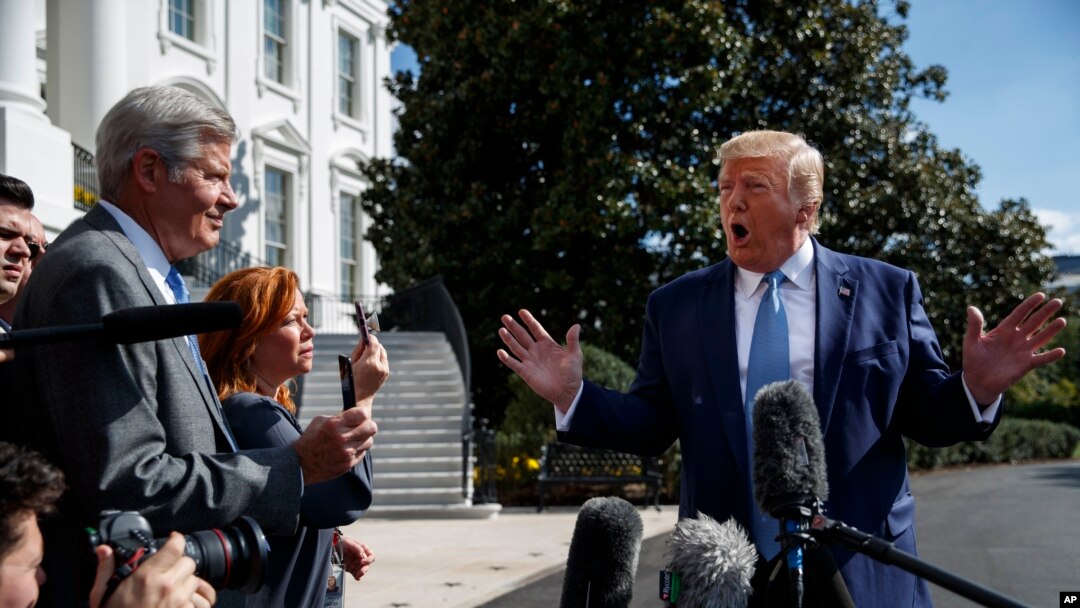 FILE - President Donald Trump talks to reporters on the South Lawn of the White House, Oct. 4, 2019.