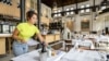 An employee prepares a cafe-restaurant for the reopening in Amsterdam, The Netherlands, on May 26, 2020, during the ongoing coronavirus pandemic (COVID-19).