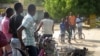 Locals say the military shot a Boko Haram fighter off his bicycle before soldiers covered the body with a tire and burned it, Maiduguri, Nigeria, Dec. 2, 2013. (Heather Murdock for VOA)