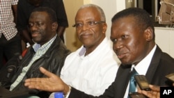 FILE - Uganda opposition leaders, from left to right: Forum for Democratic Change, Dr. Kizza Besigye, former Prime Minister Amama Mbabazi and Democratic Party President Norber Mao meet at the Democratic Alliance office in Kampala, Sept. 18, 2015.