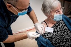 FILE - Jytte Margrete Frederiksen, 83, is one of the first Danes vaccinated against COVID-19, in Ishoj, Denmark, Dec. 27, 2020.