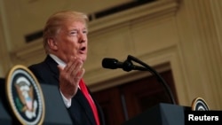 U.S. President Donald Trump answers a question at the White House in Washington, Jan. 10, 2018.