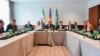 U.S. Secretary of State John Kerry sits with Saudi Arabia Foreign Minister Adel al-Jubeir (right) and Syrian Opposition Leader Dr. Riyad Nijab on Feb. 11, 2016, before a three-way meeting focused on Syria preceding the Munich Security Conference. 