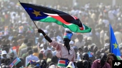 A man waves South Sudan's national flag as he attends the Independence Day celebrations in the capital Juba, July 9, 2011