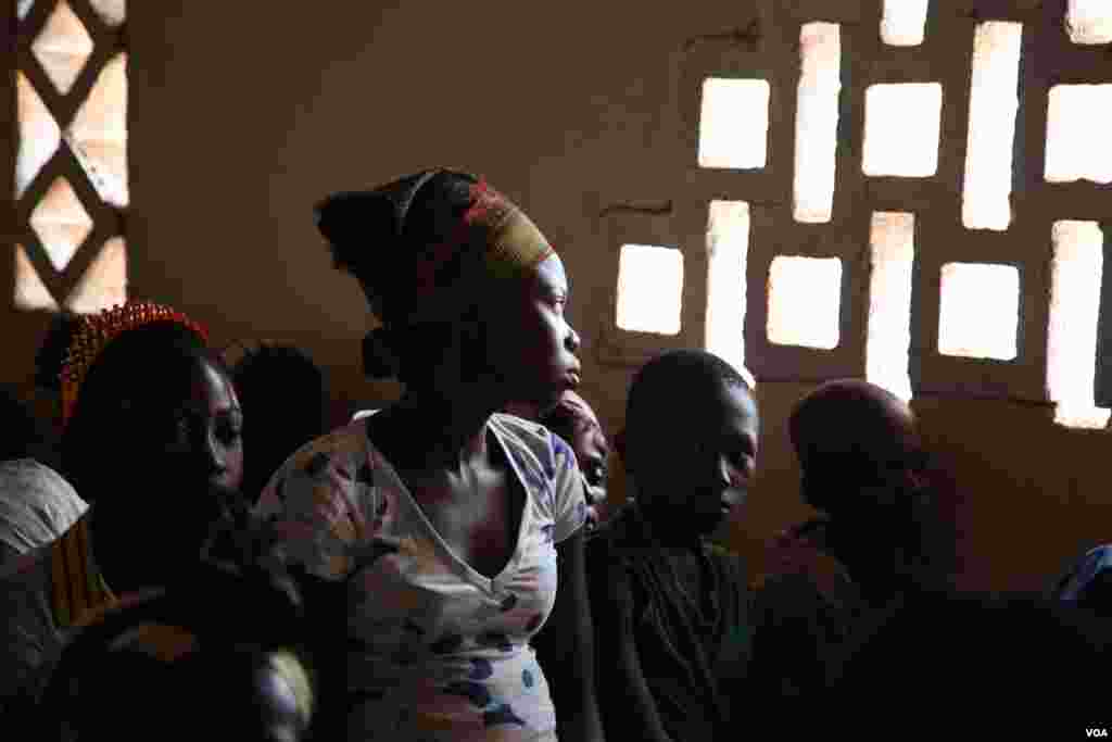 A girl stares out the window at Bossangoa chuch's Sunday prayers. Over 36,000 people are living at the site. (Hanna McNeish for VOA)