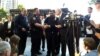 New York City Police Commissioner Bill Bratton greets Sgt. Hameed Armani, right, and Officer Peter Cybulski at a news conference at Columbus Circle in New York, July 21, 2016.