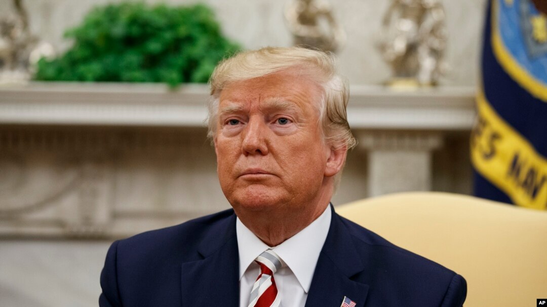 President Donald Trump pauses while speaking during a meeting with Romanian President Klaus Iohannis in the Oval Office of the White House, Aug. 20, 2019, in Washington.